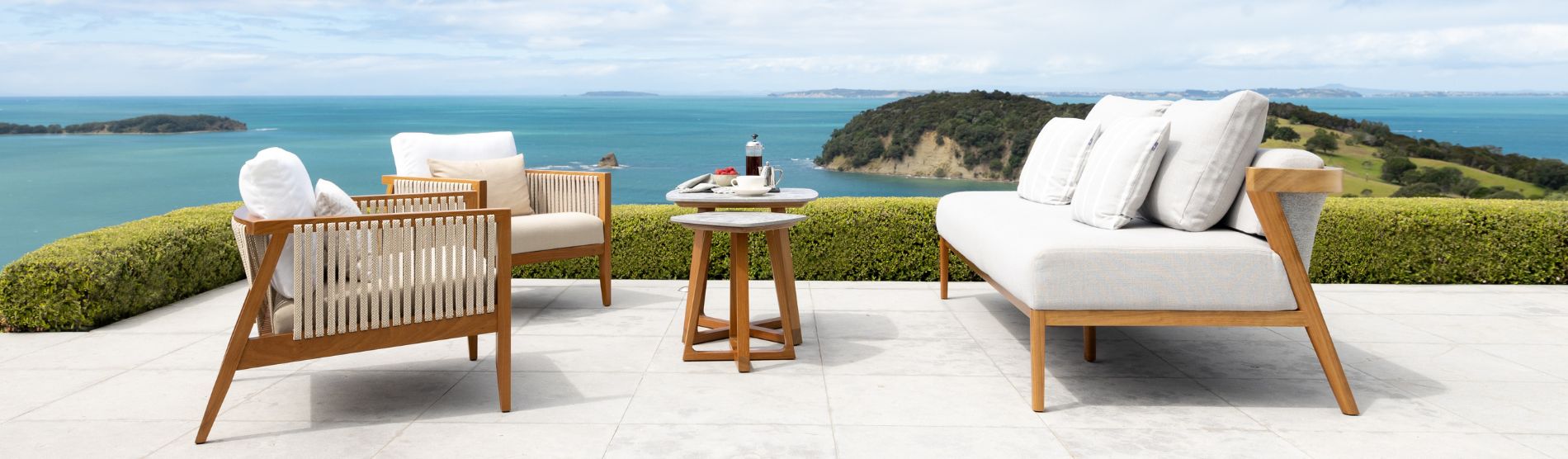 outdoor sofa, tables and chairs on terrace in New Zealand coast